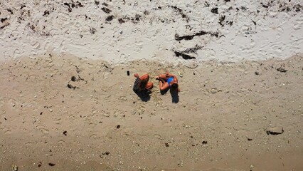 Top view shot of two females relaxing at the beach in Koh Phangan, Thailand