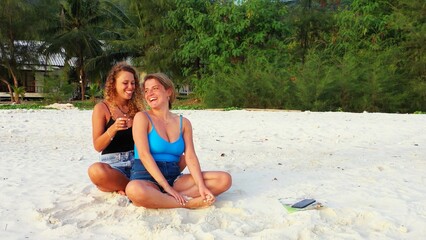 Beautiful shot of two females relaxing at the beach in Koh Phangan, Thailand