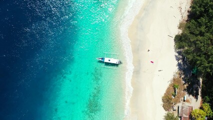 Beautiful view of a beach with a boat on sunny day in Asia