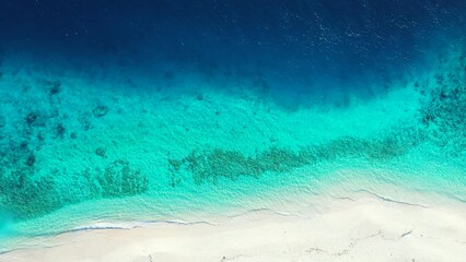 Aerial shot of  coral reefs under tranquil water in the sea