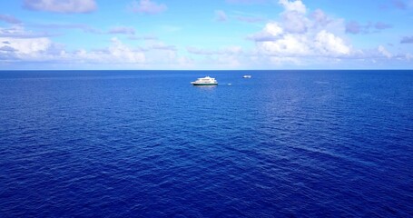 Aerial shot of a ship on a blue calm water