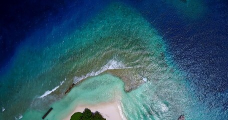 Aerial shot of ocean water covering the coastline