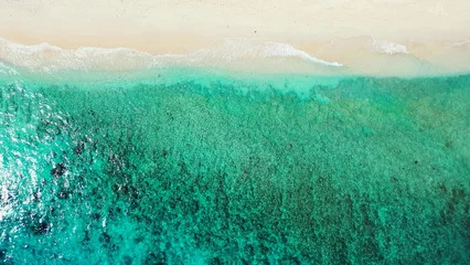 Foto auf Alu-Dibond Aerial view of a turquoise sea with soft sands beach in an island of Maldives, Asia © Wirestock
