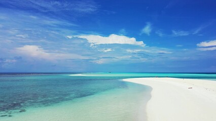 Beautiful shot of turquoise sea and white beach under cloudy sky in the Maldives