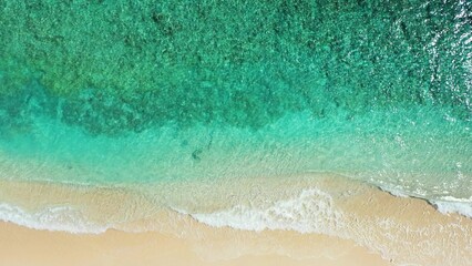 Aerial view of a turquoise sea with soft sands beach in an island of Maldives, Asia