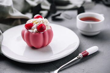 Elegant pink dessert with berries on plate