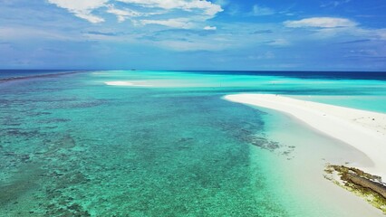Fototapeta premium Aerial view of turquoise water with coral reef and sandy beach in the Maldives