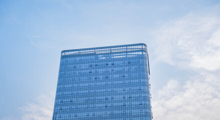 Fototapeta premium Low angle view of skyscraper with glass window and clear blue sky background for business and finance concept