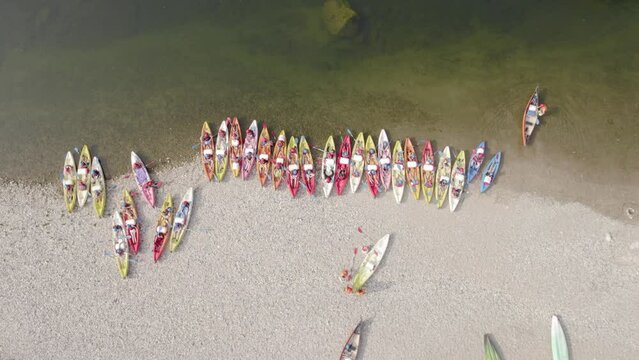 Multiple Canoe Leaving Shore After Camping - Aerial Drone Top Down