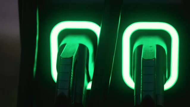 Neon green light logo on wall, powered by technology and electric blue hue