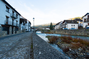 Obraz premium A small town with a river running through it Ochagavia Navarre Spain. touristic village