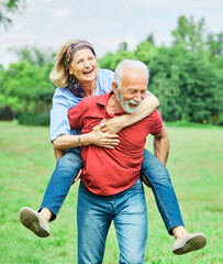 senior people couple happy elderly love together retirement  man woman mature piggyback fun