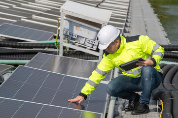 Engineer working at floating solar farm,checking and maintenance with solar batteries near solar panels,supervisor Check the system at the solar power station
