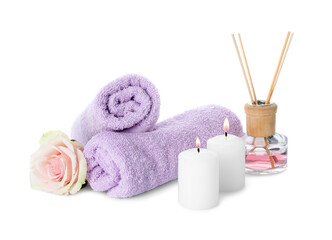 Obraz na płótnie Canvas Spa composition. Towels, burning candles, reed air freshener and rose flower on white background