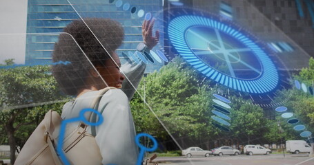 Image of scope scanning and data processing over african american woman waving