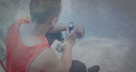 Image of connected dots, clouds against high angle view of biracial man using smartwatch - Powered by Adobe
