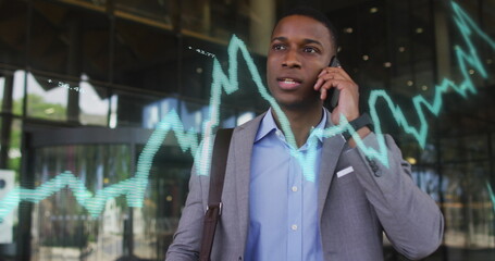 Image of data processing over african american businessman talking on smartphone