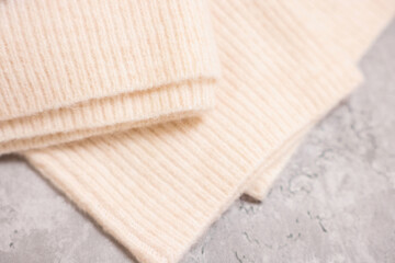 Fototapeta na wymiar Soft folded sweater on grey table, above view
