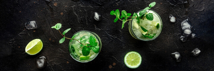 Mojito cocktail overhead flat lay panorama. Summer cold drink with lime, fresh mint, and ice. Cool...