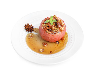 Tasty baked apple with nuts, honey and anise star isolated on white