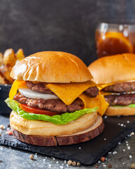 Two Burger with fries and drink, smash burger in black background