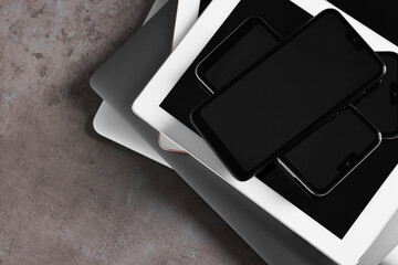 Many different modern gadgets on grey table, top view