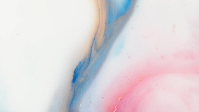 Blue red and orange liquid ink streaks in white color fluid, abstract.