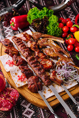 Traditional grilled shashlik skewers on wooden board