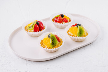 Fresh fruit tartlets on white plate