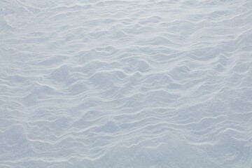 Wind has made patterns on snow surface.
