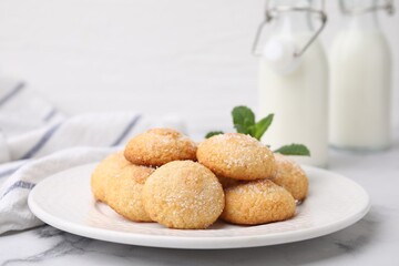Tasty sweet sugar cookies and mint on white marble table, closeup