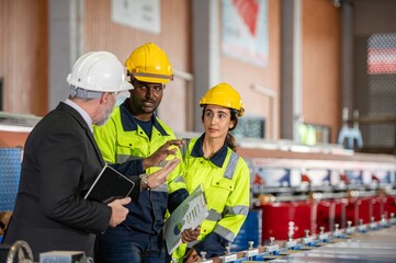 woman engineer assistant secretary in helmet inspection check control heavy machine construction installation in industrial factory with boss manager. Boss and partnership check maintenance factory