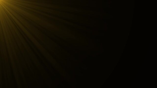Lens flare effect on black background. Rays of the morning sun. Anamorphic lens effect in yellow tone, 4K video. 
