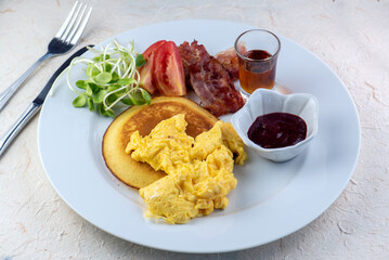 ix dish breakfast salad with fried egg, eggs Benedict, egg burrito, juice, toasted muffins, ham,...