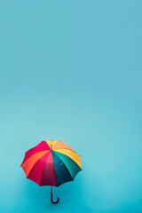 Fototapeta na wymiar An isolated umbrella on an colorful background