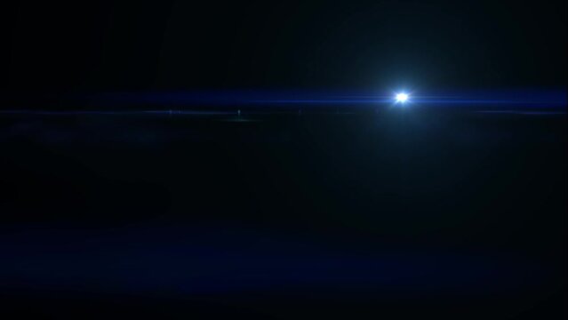 Lens flare effect on black background. Sunset in space. Anamorphic lens effect in yellow tone, 4K video. The sun moves slowly from top rigth corner to bottom left corner.