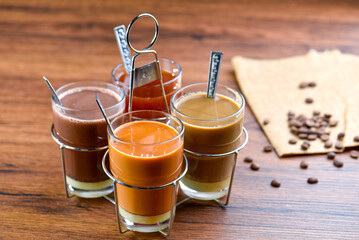 Mix Thai beverage hot drink in glass. Hot milk tea, espresso, cocoa in hand bunch is classic...