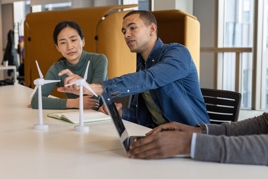 Young engineer explaining green energy technology in a meeting