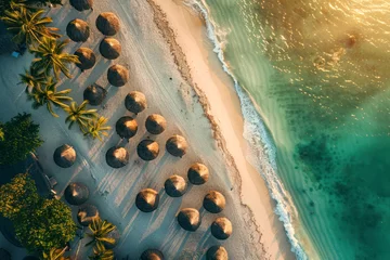 Poster Aerial view of umbrellas, palms on the sandy beach of Indian Ocean at sunset. Top view. © Hunman