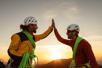 Two men are high up on a mountain, one of them is wearing a yellow jacket
