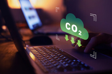 Lower CO2 emissions to limit global warming and climate change. Concept with icon on virtual screen. - 785230987