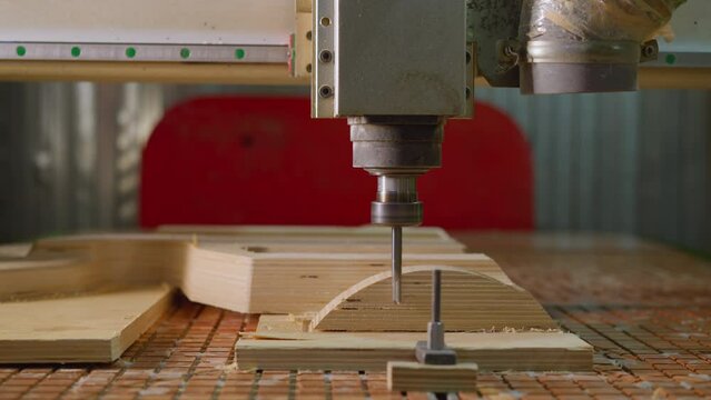 CNC router machine carving intricate pattern on plywood, industrial woodworking in action
