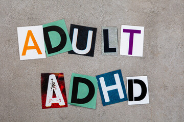 Adult ADHD written in magazine cutout letters on mottled grey