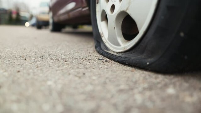 Discover the haunting beauty of an old abandoned car with a flat tire, its presence resonating even in the brightness of day