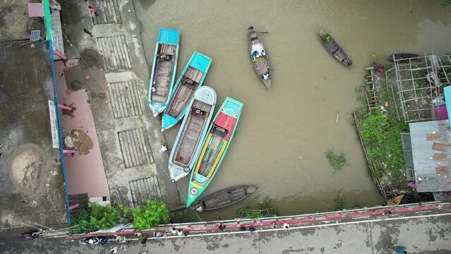 Wooden and metal boats are seen in the river which is the floating market of Bangladesh