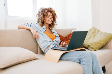 Smiling woman working on laptop in cozy living room