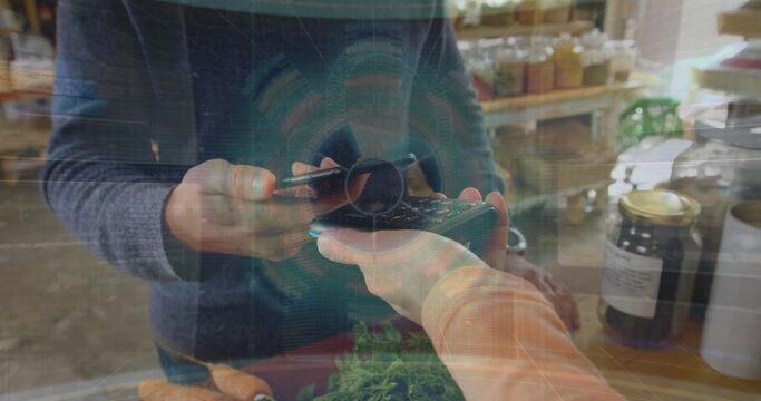 Image of data processing over biracial man paying with smartphone