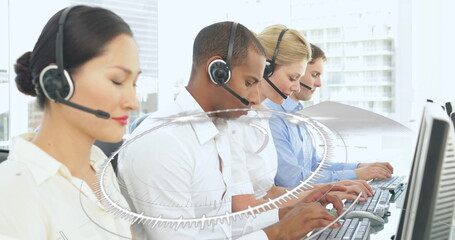 Image of network of connections over diverse office workers wearing headsets