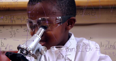 Image of mathematical formulae over smiling schoolboy using microscope - obrazy, fototapety, plakaty