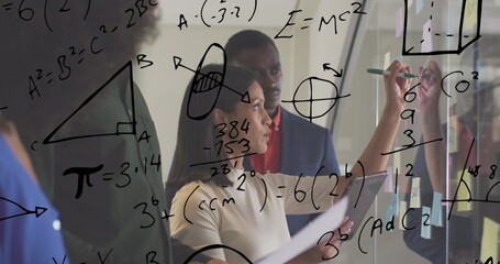 Multiple mathematical equations against diverse office colleagues writing on glass board at office